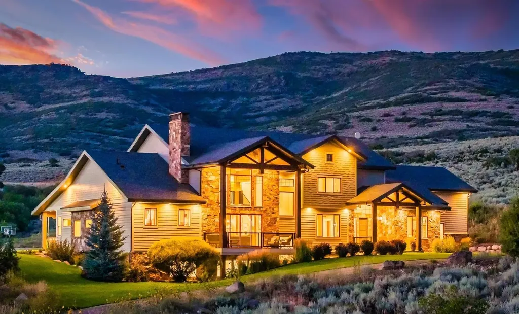 4115 Greener Hills Drive Home in Heber, Utah. Discover a 7.55-acre gated estate in Greener Hills. This luxury property features remarkable entertainment amenities, from exposed wood beams to a gourmet kitchen with Wolf appliances, an outdoor kitchen, pool, and firepit. The main level master offers radiant heat flooring, and the estate includes a playhouse, home theater, and more.