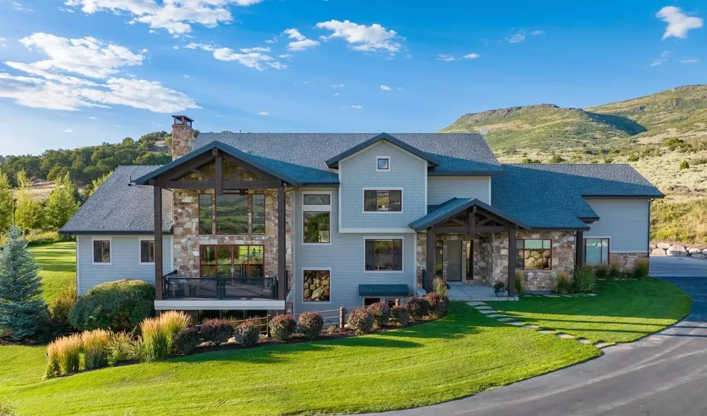 4115 Greener Hills Drive Home in Heber, Utah. Discover a 7.55-acre gated estate in Greener Hills. This luxury property features remarkable entertainment amenities, from exposed wood beams to a gourmet kitchen with Wolf appliances, an outdoor kitchen, pool, and firepit. The main level master offers radiant heat flooring, and the estate includes a playhouse, home theater, and more.