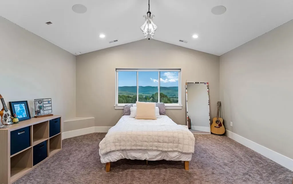 4115 Greener Hills Drive Home in Heber, Utah. Discover a 7.55-acre gated estate in Greener Hills. This luxury property features remarkable entertainment amenities, from exposed wood beams to a gourmet kitchen with Wolf appliances, an outdoor kitchen, pool, and firepit. The main level master offers radiant heat flooring, and the estate includes a playhouse, home theater, and more.