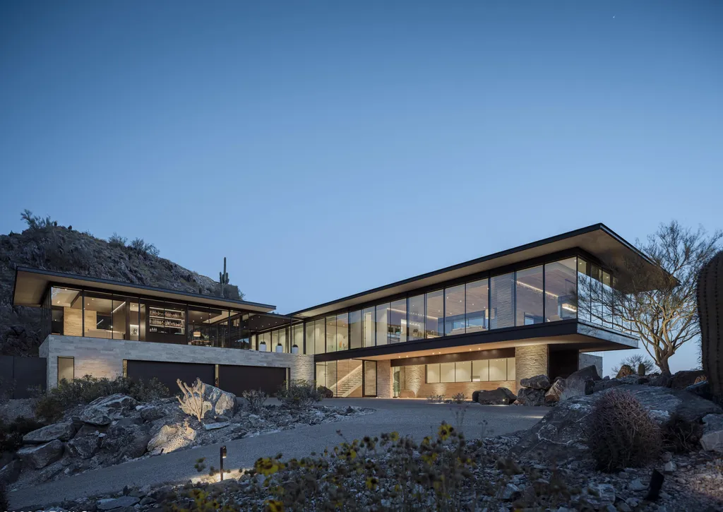 4301 E Upper Ridge Way Home in Paradise Valley, Arizona. Perched between two mountain peaks, the Upper Ridge Residence is an 8,000+ sf modern marvel designed by The Construction Zone. Featuring panoramic Valley of the Sun views, this steel and glass pavilion offers the highest level of craftsmanship.