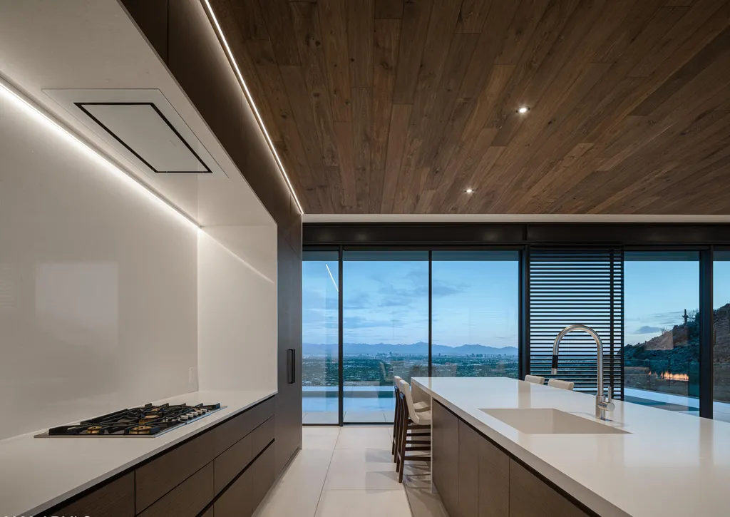 4301 E Upper Ridge Way Home in Paradise Valley, Arizona. Perched between two mountain peaks, the Upper Ridge Residence is an 8,000+ sf modern marvel designed by The Construction Zone. Featuring panoramic Valley of the Sun views, this steel and glass pavilion offers the highest level of craftsmanship.