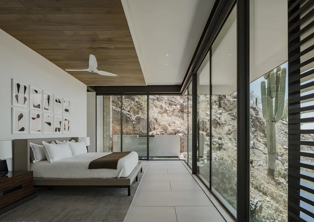 4301 E Upper Ridge Way Home in Paradise Valley, Arizona. Perched between two mountain peaks, the Upper Ridge Residence is an 8,000+ sf modern marvel designed by The Construction Zone. Featuring panoramic Valley of the Sun views, this steel and glass pavilion offers the highest level of craftsmanship.