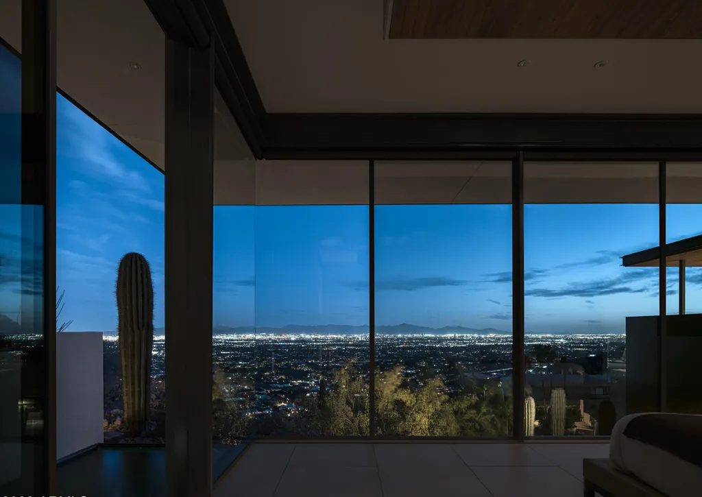 4301 E Upper Ridge Way Home in Paradise Valley, Arizona. Perched between two mountain peaks, the Upper Ridge Residence is an 8,000+ sf modern marvel designed by The Construction Zone. Featuring panoramic Valley of the Sun views, this steel and glass pavilion offers the highest level of craftsmanship.