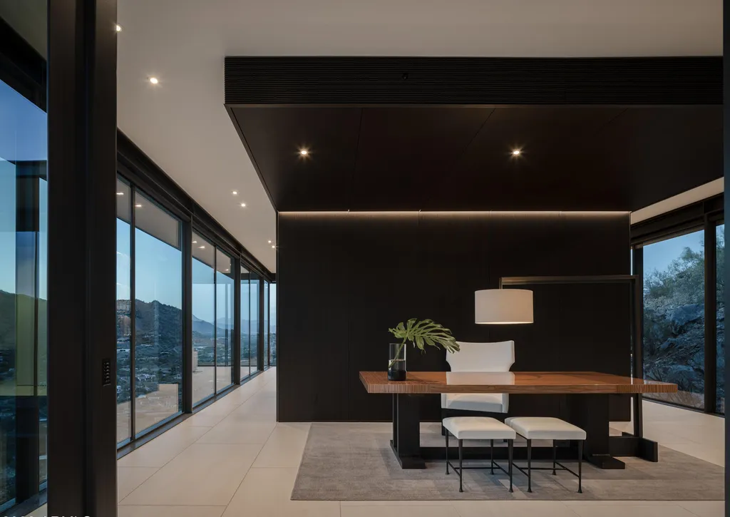 4301 E Upper Ridge Way Home in Paradise Valley, Arizona. Perched between two mountain peaks, the Upper Ridge Residence is an 8,000+ sf modern marvel designed by The Construction Zone. Featuring panoramic Valley of the Sun views, this steel and glass pavilion offers the highest level of craftsmanship.