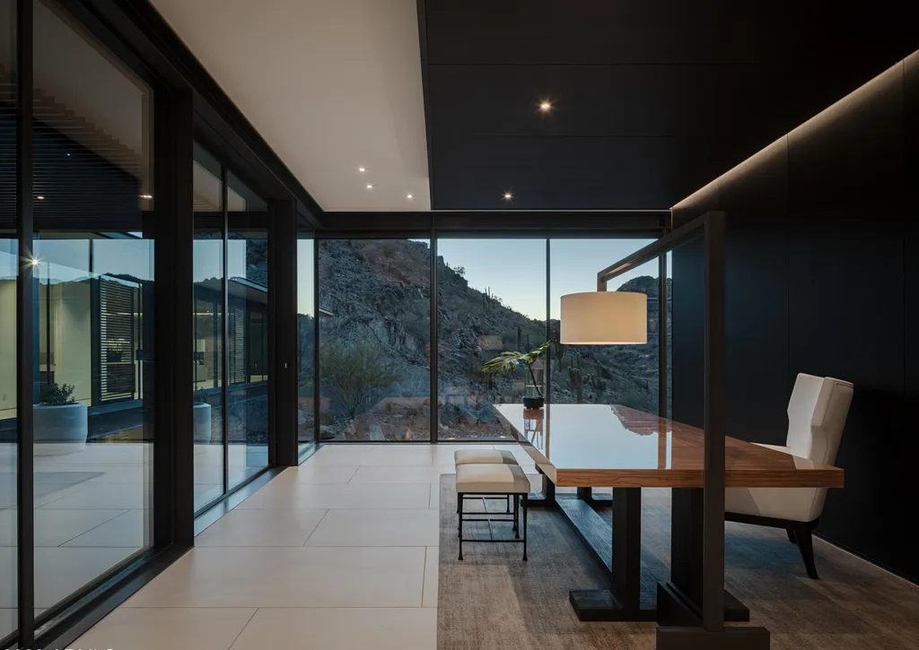 4301 E Upper Ridge Way Home in Paradise Valley, Arizona. Perched between two mountain peaks, the Upper Ridge Residence is an 8,000+ sf modern marvel designed by The Construction Zone. Featuring panoramic Valley of the Sun views, this steel and glass pavilion offers the highest level of craftsmanship.