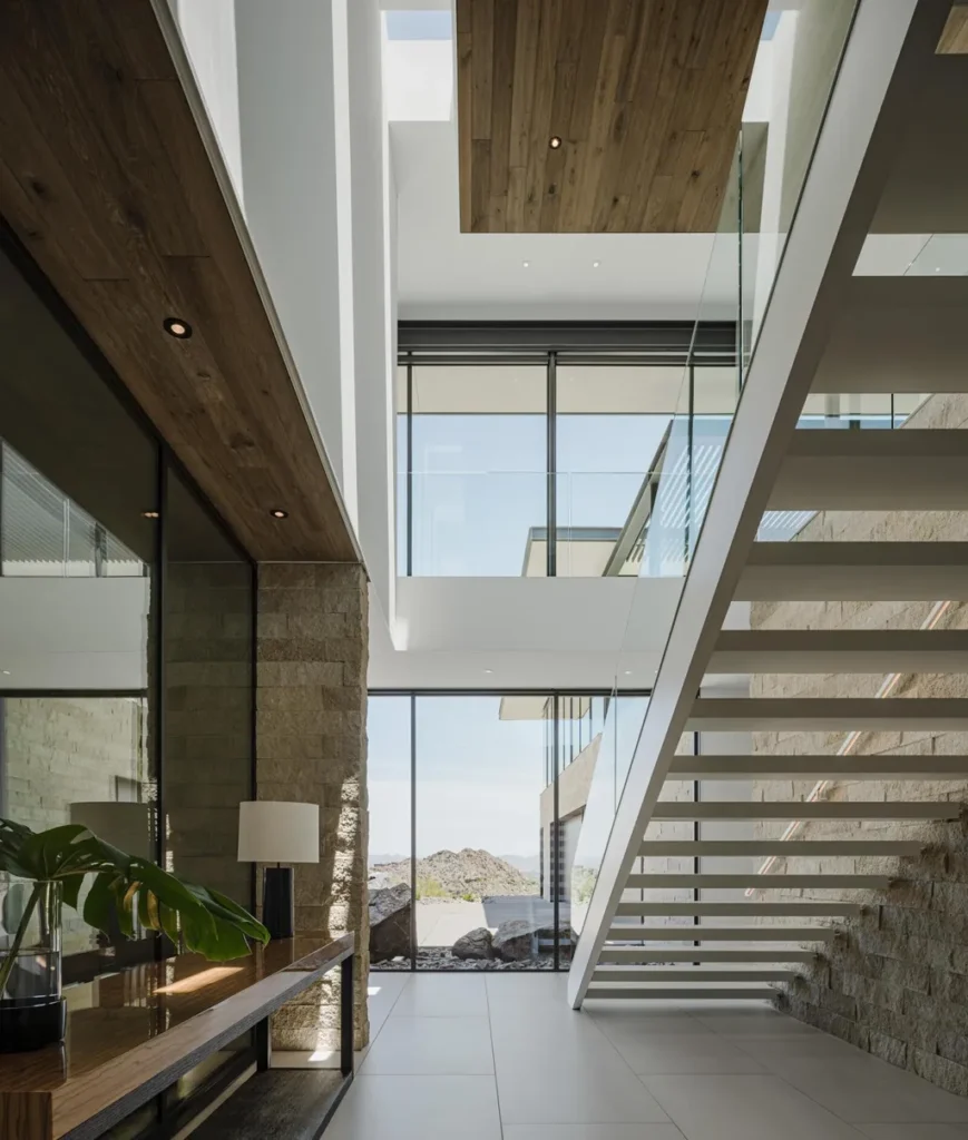 4301 E Upper Ridge Way Home in Paradise Valley, Arizona. Perched between two mountain peaks, the Upper Ridge Residence is an 8,000+ sf modern marvel designed by The Construction Zone. Featuring panoramic Valley of the Sun views, this steel and glass pavilion offers the highest level of craftsmanship.