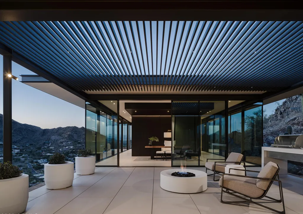 4301 E Upper Ridge Way Home in Paradise Valley, Arizona. Perched between two mountain peaks, the Upper Ridge Residence is an 8,000+ sf modern marvel designed by The Construction Zone. Featuring panoramic Valley of the Sun views, this steel and glass pavilion offers the highest level of craftsmanship.