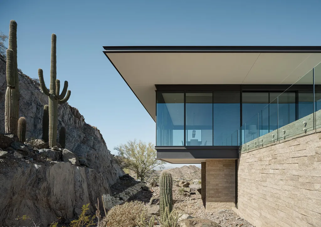 4301 E Upper Ridge Way Home in Paradise Valley, Arizona. Perched between two mountain peaks, the Upper Ridge Residence is an 8,000+ sf modern marvel designed by The Construction Zone. Featuring panoramic Valley of the Sun views, this steel and glass pavilion offers the highest level of craftsmanship.