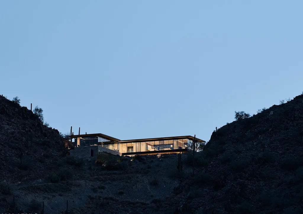 4301 E Upper Ridge Way Home in Paradise Valley, Arizona. Perched between two mountain peaks, the Upper Ridge Residence is an 8,000+ sf modern marvel designed by The Construction Zone. Featuring panoramic Valley of the Sun views, this steel and glass pavilion offers the highest level of craftsmanship.
