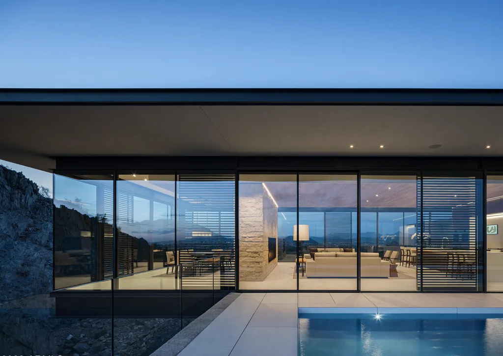 4301 E Upper Ridge Way Home in Paradise Valley, Arizona. Perched between two mountain peaks, the Upper Ridge Residence is an 8,000+ sf modern marvel designed by The Construction Zone. Featuring panoramic Valley of the Sun views, this steel and glass pavilion offers the highest level of craftsmanship.
