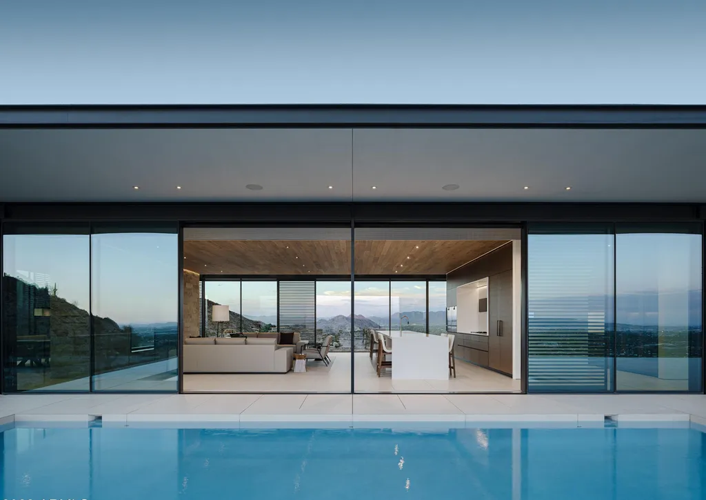 4301 E Upper Ridge Way Home in Paradise Valley, Arizona. Perched between two mountain peaks, the Upper Ridge Residence is an 8,000+ sf modern marvel designed by The Construction Zone. Featuring panoramic Valley of the Sun views, this steel and glass pavilion offers the highest level of craftsmanship.