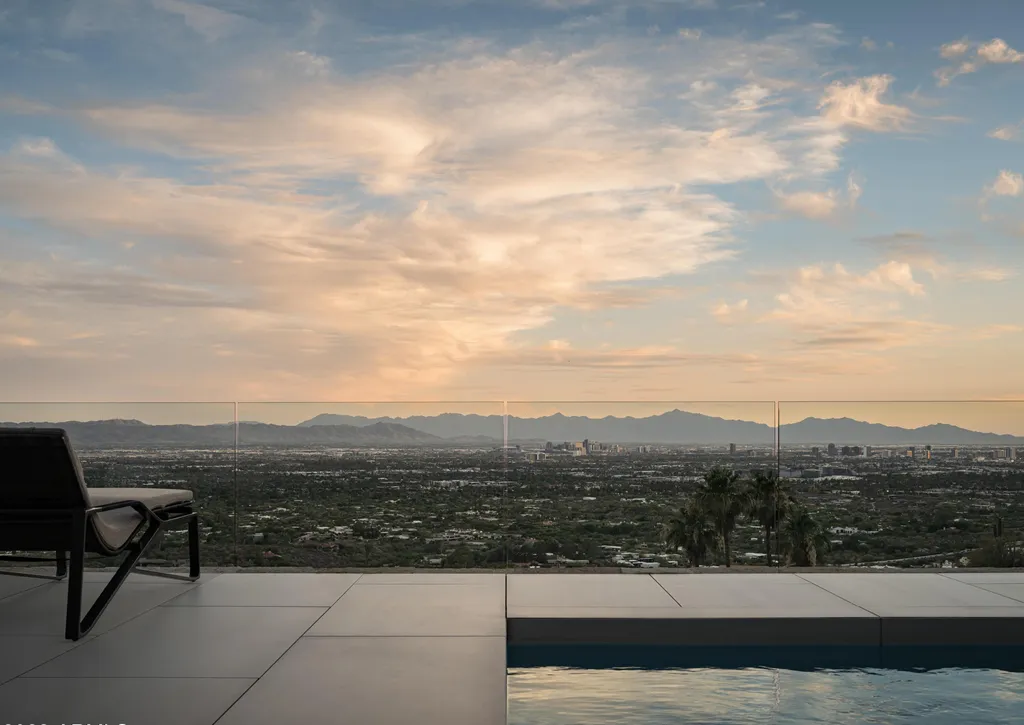 4301 E Upper Ridge Way Home in Paradise Valley, Arizona. Perched between two mountain peaks, the Upper Ridge Residence is an 8,000+ sf modern marvel designed by The Construction Zone. Featuring panoramic Valley of the Sun views, this steel and glass pavilion offers the highest level of craftsmanship.