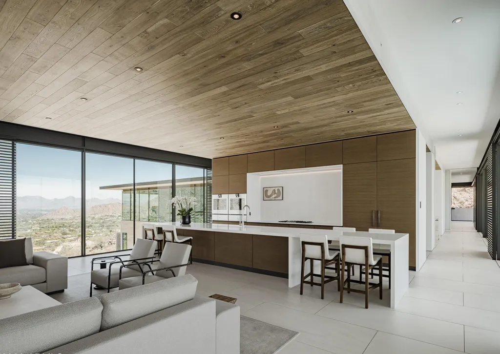 4301 E Upper Ridge Way Home in Paradise Valley, Arizona. Perched between two mountain peaks, the Upper Ridge Residence is an 8,000+ sf modern marvel designed by The Construction Zone. Featuring panoramic Valley of the Sun views, this steel and glass pavilion offers the highest level of craftsmanship.