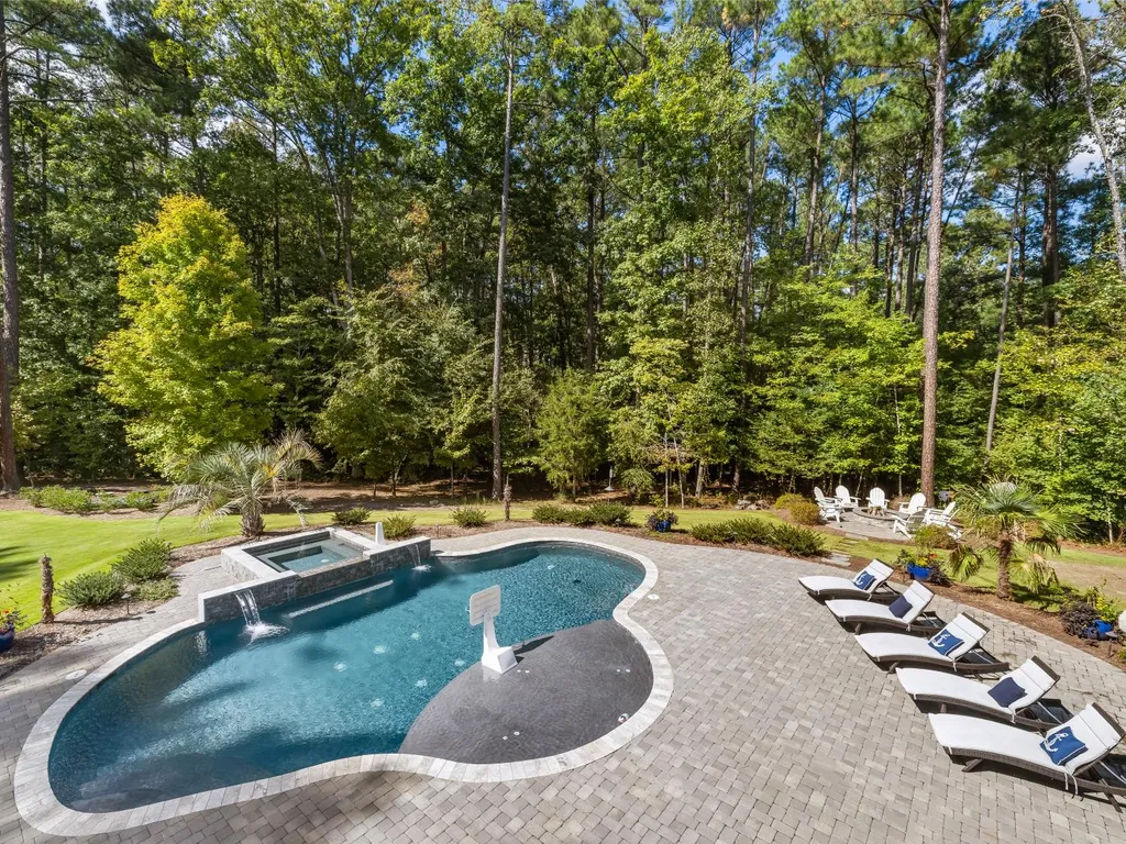53 Topaz Jewel Court Home in Durham, North Carolina. Step into an extraordinary opportunity to own an ultra-luxury home in a coveted, fully fenced, and gated community, nestled within 5+ pristine acres. This magnificent estate represents the epitome of elegance and sophistication, boasting superior craftsmanship and unparalleled attention to detail at every turn.