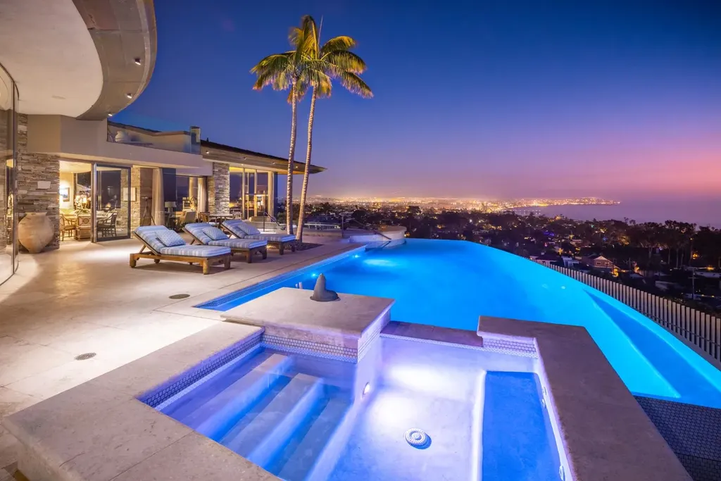 5740 La Jolla Corona Drive Home in La Jolla, California. Discover SEAVIEW, a stunning 5-bedroom architectural marvel in San Diego that offers an extraordinary 260-degree panorama of the ocean. This 8,810 sq ft estate, designed by Island Architects and constructed by Wardell Builders, exudes opulence with its saltwater infinity pool, fresh-water ponds, and lavish interiors. 