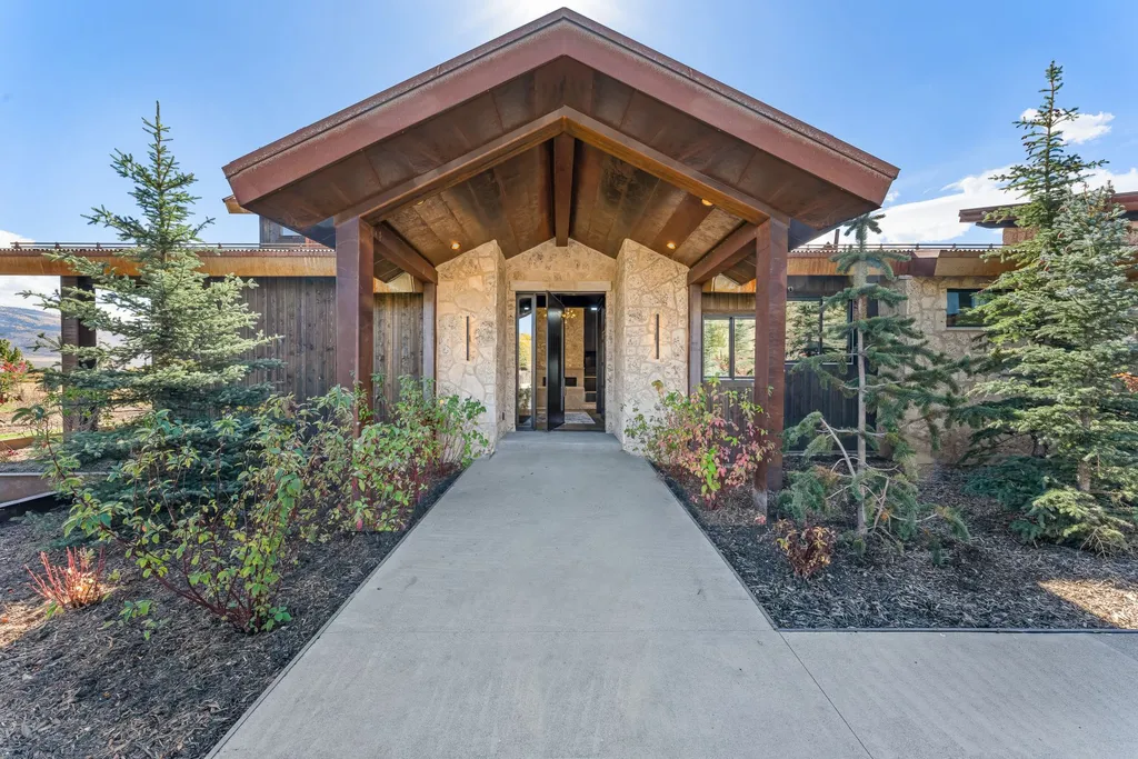 5930 N Triple Crown Trail Home in Oakley, Utah. NorthStar Ranch is a breathtaking mountain contemporary home nestled on over eight acres of serene landscape in Summit County. With two main floor primary suites, a six-car garage, and stunning views of Mt. Timpanogos and Park City ski resorts, this property offers a perfect blend of luxury and natural beauty.