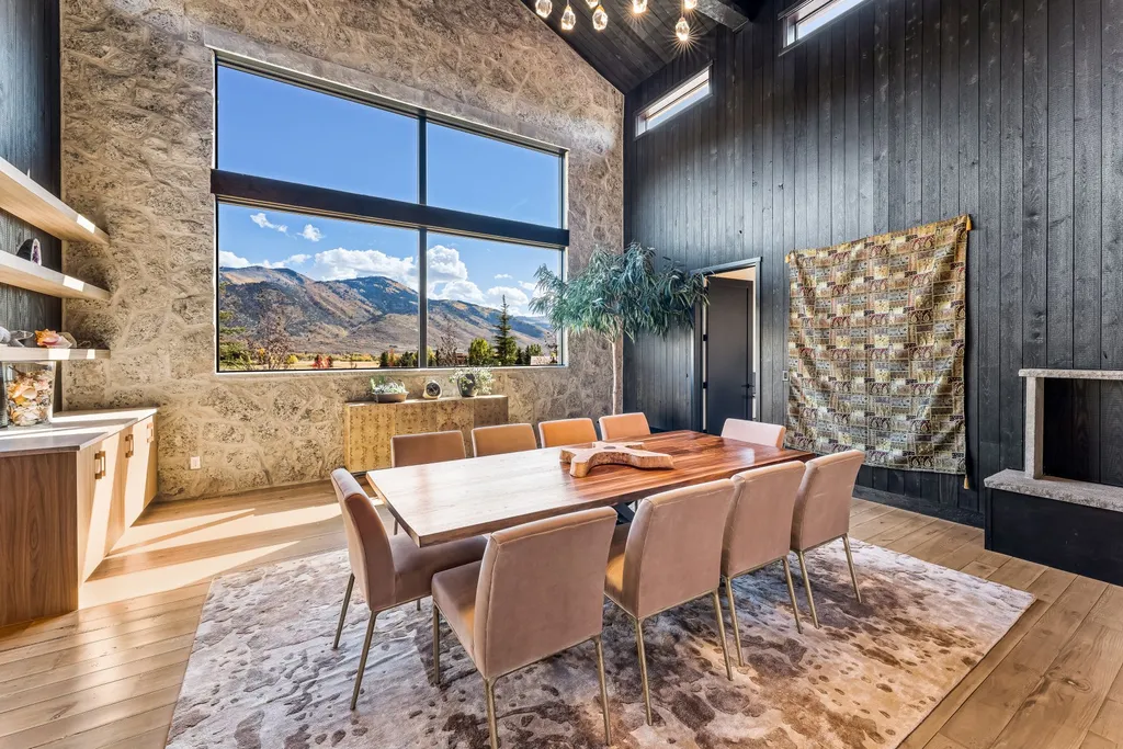 5930 N Triple Crown Trail Home in Oakley, Utah. NorthStar Ranch is a breathtaking mountain contemporary home nestled on over eight acres of serene landscape in Summit County. With two main floor primary suites, a six-car garage, and stunning views of Mt. Timpanogos and Park City ski resorts, this property offers a perfect blend of luxury and natural beauty.