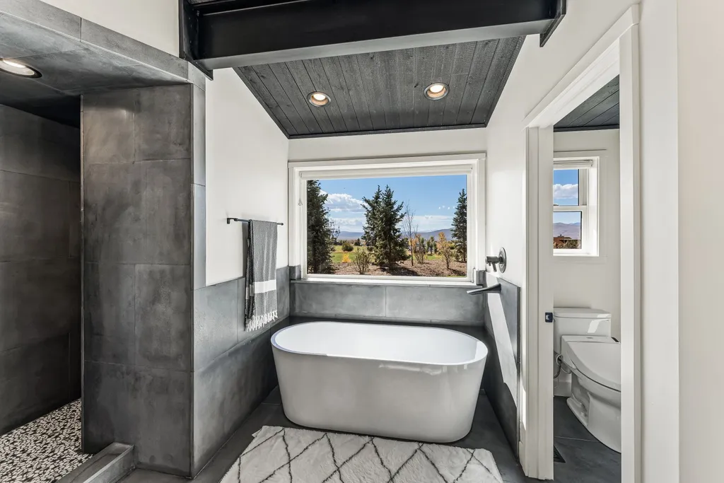 5930 N Triple Crown Trail Home in Oakley, Utah. NorthStar Ranch is a breathtaking mountain contemporary home nestled on over eight acres of serene landscape in Summit County. With two main floor primary suites, a six-car garage, and stunning views of Mt. Timpanogos and Park City ski resorts, this property offers a perfect blend of luxury and natural beauty.