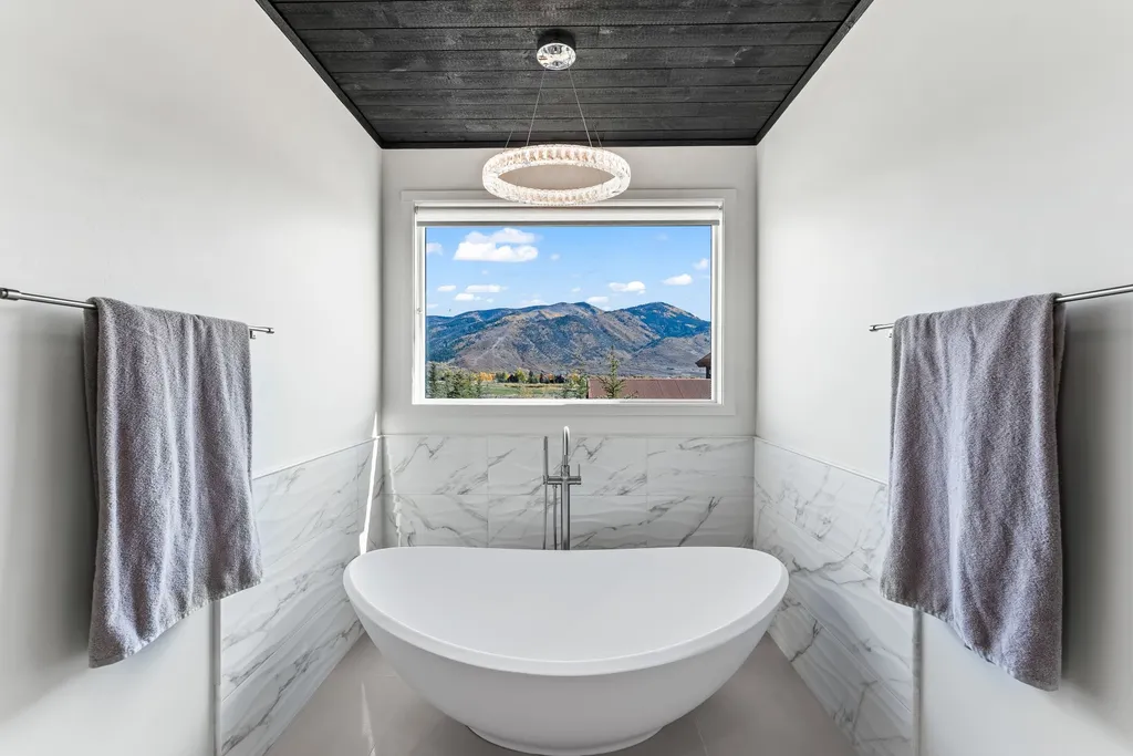 5930 N Triple Crown Trail Home in Oakley, Utah. NorthStar Ranch is a breathtaking mountain contemporary home nestled on over eight acres of serene landscape in Summit County. With two main floor primary suites, a six-car garage, and stunning views of Mt. Timpanogos and Park City ski resorts, this property offers a perfect blend of luxury and natural beauty.