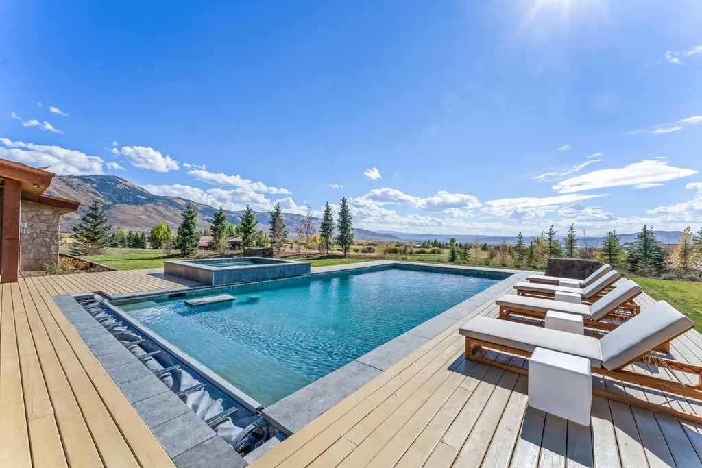 5930 N Triple Crown Trail Home in Oakley, Utah. NorthStar Ranch is a breathtaking mountain contemporary home nestled on over eight acres of serene landscape in Summit County. With two main floor primary suites, a six-car garage, and stunning views of Mt. Timpanogos and Park City ski resorts, this property offers a perfect blend of luxury and natural beauty.