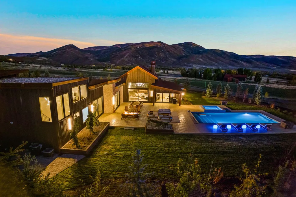 5930 N Triple Crown Trail Home in Oakley, Utah. NorthStar Ranch is a breathtaking mountain contemporary home nestled on over eight acres of serene landscape in Summit County. With two main floor primary suites, a six-car garage, and stunning views of Mt. Timpanogos and Park City ski resorts, this property offers a perfect blend of luxury and natural beauty.