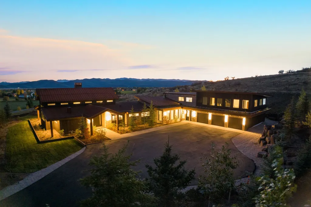5930 N Triple Crown Trail Home in Oakley, Utah. NorthStar Ranch is a breathtaking mountain contemporary home nestled on over eight acres of serene landscape in Summit County. With two main floor primary suites, a six-car garage, and stunning views of Mt. Timpanogos and Park City ski resorts, this property offers a perfect blend of luxury and natural beauty.