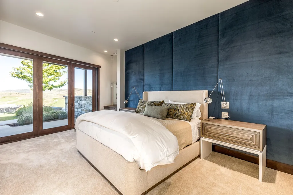 7235 North Starlight Circle Home in Kamas, Utah. Experience ultimate luxury living in this exceptional 5-bedroom, 5 ½-bathroom masterpiece spanning 6,270 square feet. Embrace the outdoors with folding glass doors leading to a heated patio, infinity spa pool, and landscaped yard with stunning Deer Valley and Jordanelle Reservoir views.