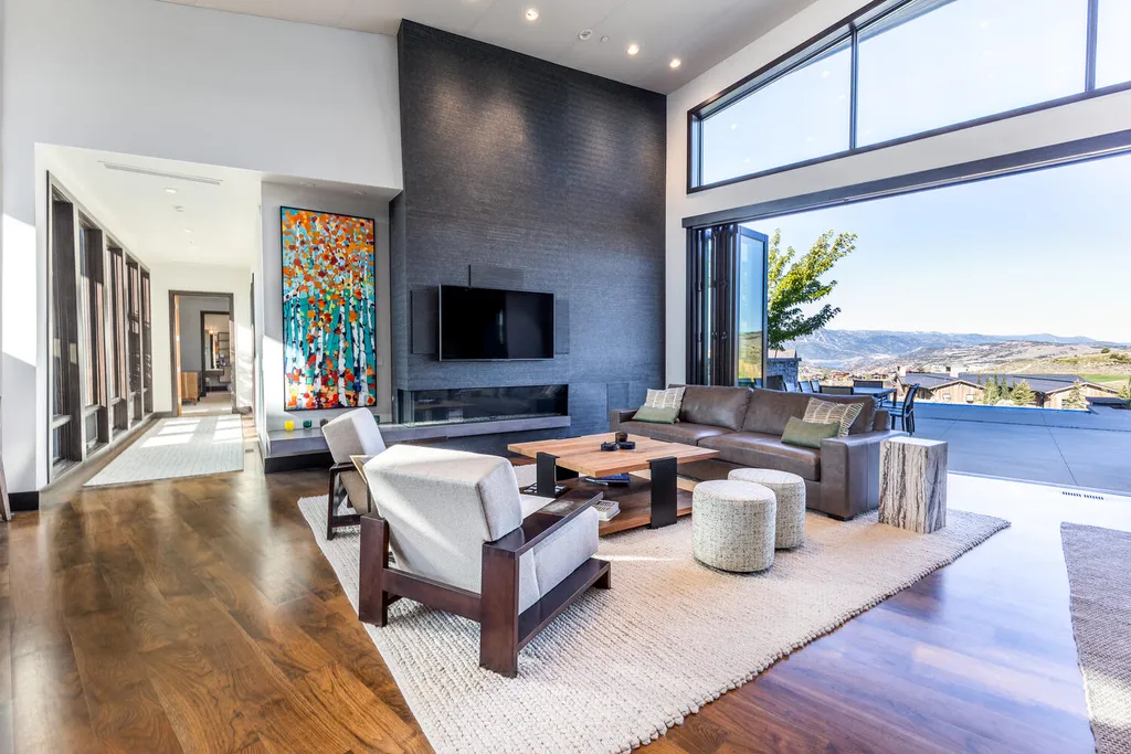 7235 North Starlight Circle Home in Kamas, Utah. Experience ultimate luxury living in this exceptional 5-bedroom, 5 ½-bathroom masterpiece spanning 6,270 square feet. Embrace the outdoors with folding glass doors leading to a heated patio, infinity spa pool, and landscaped yard with stunning Deer Valley and Jordanelle Reservoir views.