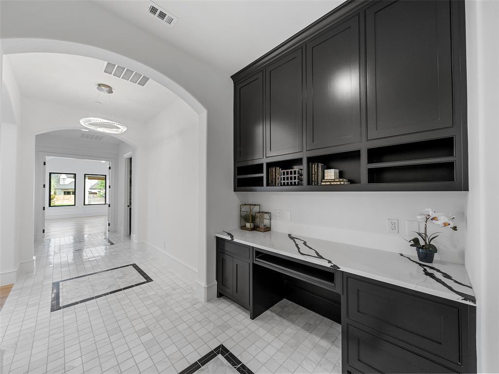 892 Ethel Marie Drive Home in Fairview, Texas. Discover the epitome of luxury living in this stunning Homes By J. Anthony masterpiece, boasting over 7,800 sq ft in Fairview's prestigious Chamberlain Place subdivision. This meticulously updated one-story design offers an array of features, including a gourmet kitchen, wine bar, spacious bedrooms, and a pool overlooking an outdoor dining area.