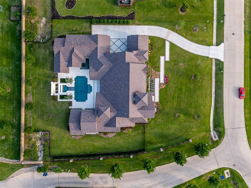 892 Ethel Marie Drive Home in Fairview, Texas. Discover the epitome of luxury living in this stunning Homes By J. Anthony masterpiece, boasting over 7,800 sq ft in Fairview's prestigious Chamberlain Place subdivision. This meticulously updated one-story design offers an array of features, including a gourmet kitchen, wine bar, spacious bedrooms, and a pool overlooking an outdoor dining area.
