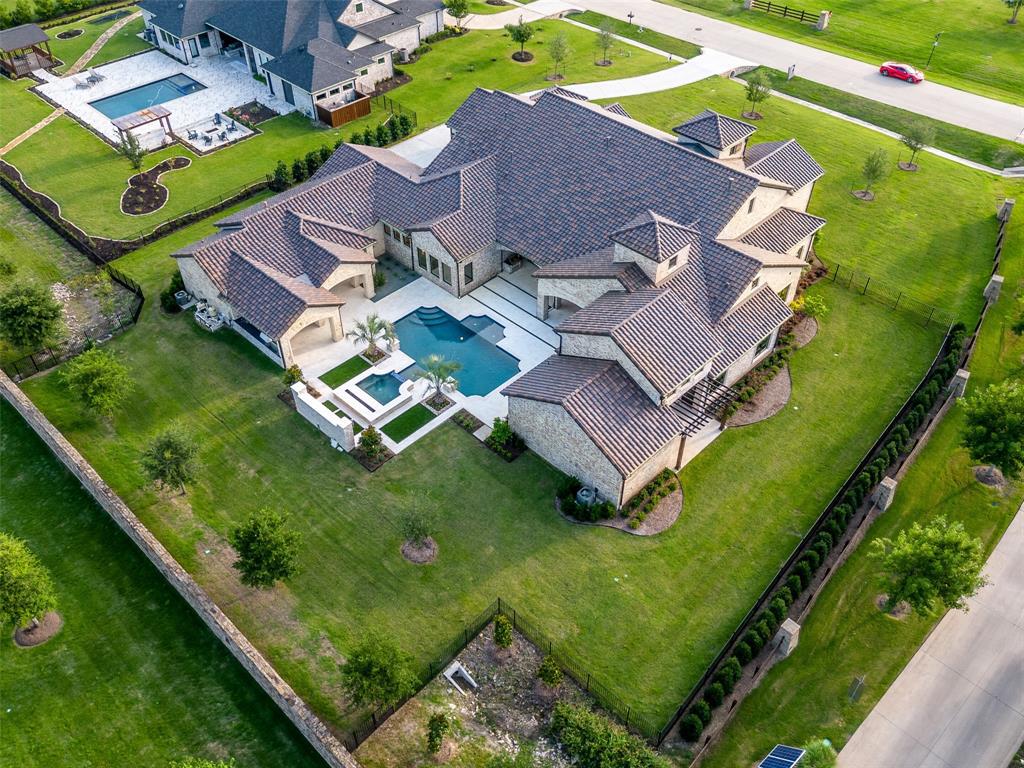 892 Ethel Marie Drive Home in Fairview, Texas. Discover the epitome of luxury living in this stunning Homes By J. Anthony masterpiece, boasting over 7,800 sq ft in Fairview's prestigious Chamberlain Place subdivision. This meticulously updated one-story design offers an array of features, including a gourmet kitchen, wine bar, spacious bedrooms, and a pool overlooking an outdoor dining area.