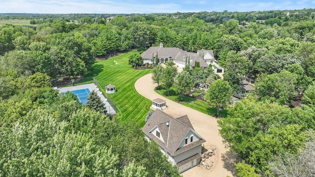 9130 195th Street East Home in Prior Lake, Minnesota. Escape to this remarkable 10-acre estate, featuring a gated entrance, a serene pond with a captivating waterfall, and luxurious amenities. With re-finished Brazilian Cherry hardwood floors, a lower-level entertainment haven, heated pool, guest house, 7-car detached garage, tennis court, and more, this property offers endless possibilities for recreation and relaxation.