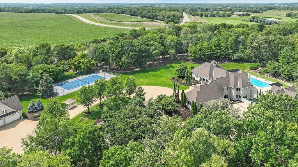 9130 195th Street East Home in Prior Lake, Minnesota. Escape to this remarkable 10-acre estate, featuring a gated entrance, a serene pond with a captivating waterfall, and luxurious amenities. With re-finished Brazilian Cherry hardwood floors, a lower-level entertainment haven, heated pool, guest house, 7-car detached garage, tennis court, and more, this property offers endless possibilities for recreation and relaxation.