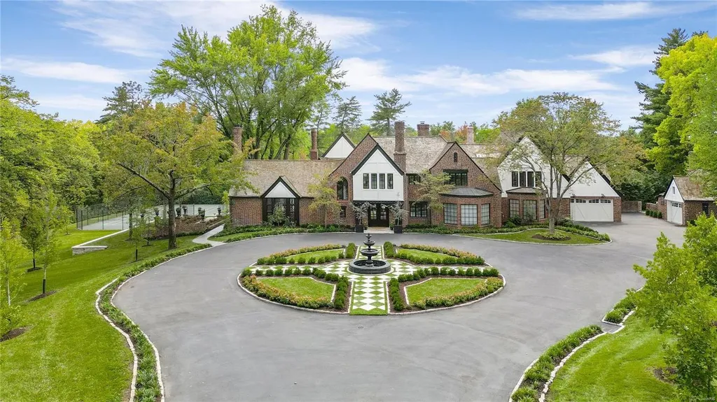 9948 Litzsinger Road Home in Saint Louis, Missouri. Step into the timeless charm of Galloway Manor, a beautifully renovated Tudor estate that seamlessly blends historic character with modern luxury. Enjoy stunning entertaining spaces, a designer kitchen, a courtyard terrace overlooking the pool and tennis court, a main floor primary suite with a showstopping walk-in closet, and much more. 