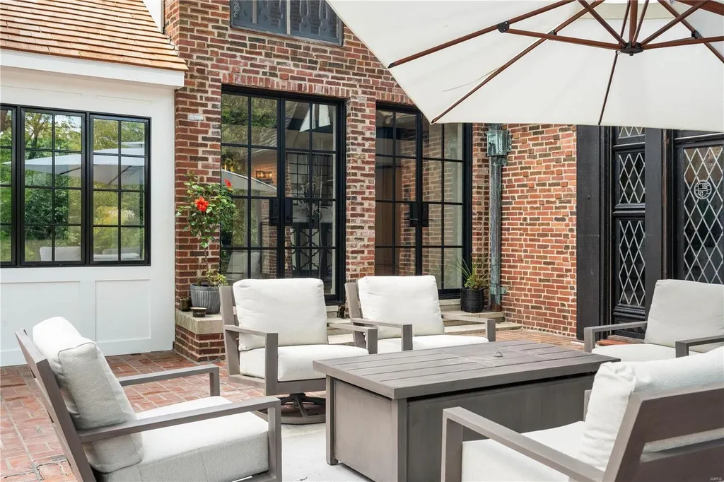 9948 Litzsinger Road Home in Saint Louis, Missouri. Step into the timeless charm of Galloway Manor, a beautifully renovated Tudor estate that seamlessly blends historic character with modern luxury. Enjoy stunning entertaining spaces, a designer kitchen, a courtyard terrace overlooking the pool and tennis court, a main floor primary suite with a showstopping walk-in closet, and much more. 