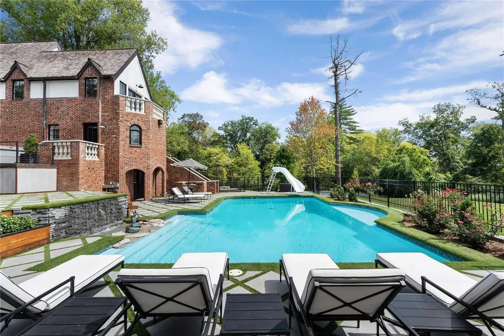 9948 Litzsinger Road Home in Saint Louis, Missouri. Step into the timeless charm of Galloway Manor, a beautifully renovated Tudor estate that seamlessly blends historic character with modern luxury. Enjoy stunning entertaining spaces, a designer kitchen, a courtyard terrace overlooking the pool and tennis court, a main floor primary suite with a showstopping walk-in closet, and much more. 