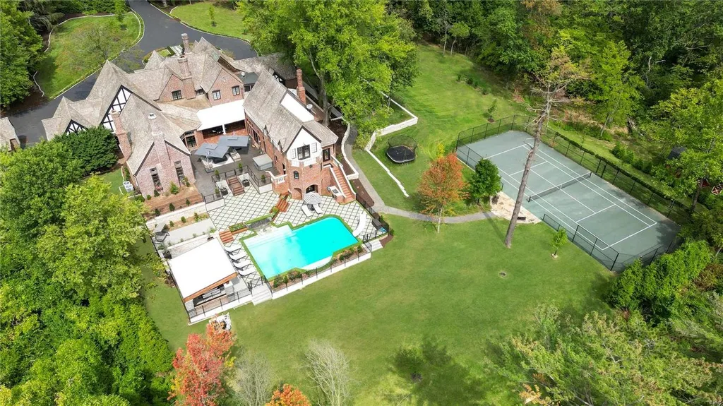 9948 Litzsinger Road Home in Saint Louis, Missouri. Step into the timeless charm of Galloway Manor, a beautifully renovated Tudor estate that seamlessly blends historic character with modern luxury. Enjoy stunning entertaining spaces, a designer kitchen, a courtyard terrace overlooking the pool and tennis court, a main floor primary suite with a showstopping walk-in closet, and much more. 