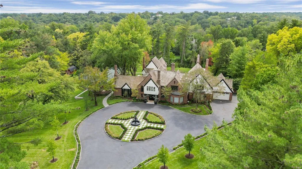 9948 Litzsinger Road Home in Saint Louis, Missouri. Step into the timeless charm of Galloway Manor, a beautifully renovated Tudor estate that seamlessly blends historic character with modern luxury. Enjoy stunning entertaining spaces, a designer kitchen, a courtyard terrace overlooking the pool and tennis court, a main floor primary suite with a showstopping walk-in closet, and much more. 