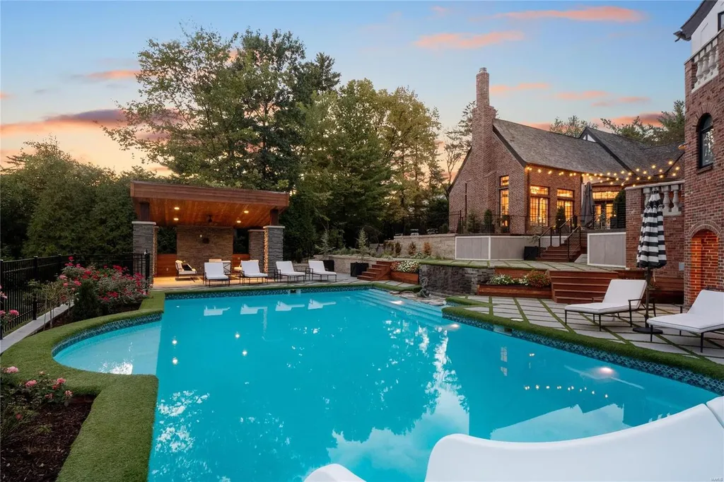 9948 Litzsinger Road Home in Saint Louis, Missouri. Step into the timeless charm of Galloway Manor, a beautifully renovated Tudor estate that seamlessly blends historic character with modern luxury. Enjoy stunning entertaining spaces, a designer kitchen, a courtyard terrace overlooking the pool and tennis court, a main floor primary suite with a showstopping walk-in closet, and much more. 