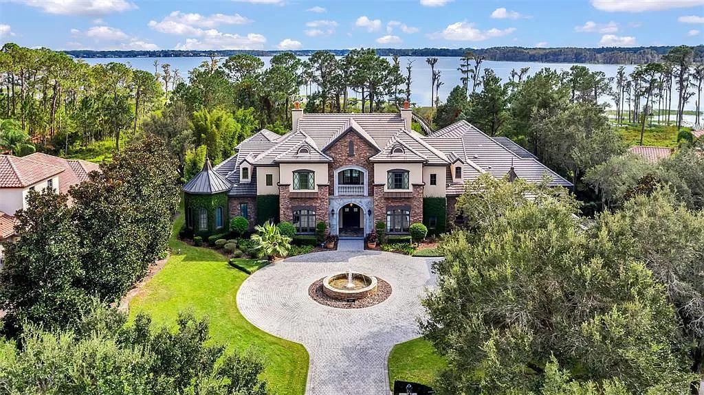 Situated within Windermere's exclusive community, this 10,485-square-foot estate at 6507 Rosella Ct embodies luxury living at its peak. Built by Stonebridge Custom Homes in 2007, the 7-bedroom, 8-bathroom property features an impressive array of amenities including a grand atrium with stunning lake views, a theater, two swimming pools, a spa, and an outdoor kitchen.