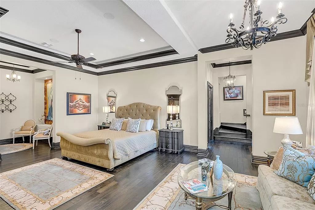 Situated within Windermere's exclusive community, this 10,485-square-foot estate at 6507 Rosella Ct embodies luxury living at its peak. Built by Stonebridge Custom Homes in 2007, the 7-bedroom, 8-bathroom property features an impressive array of amenities including a grand atrium with stunning lake views, a theater, two swimming pools, a spa, and an outdoor kitchen.