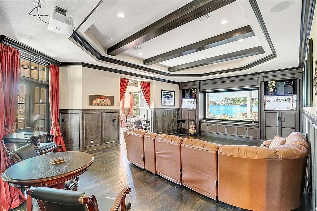 Situated within Windermere's exclusive community, this 10,485-square-foot estate at 6507 Rosella Ct embodies luxury living at its peak. Built by Stonebridge Custom Homes in 2007, the 7-bedroom, 8-bathroom property features an impressive array of amenities including a grand atrium with stunning lake views, a theater, two swimming pools, a spa, and an outdoor kitchen.