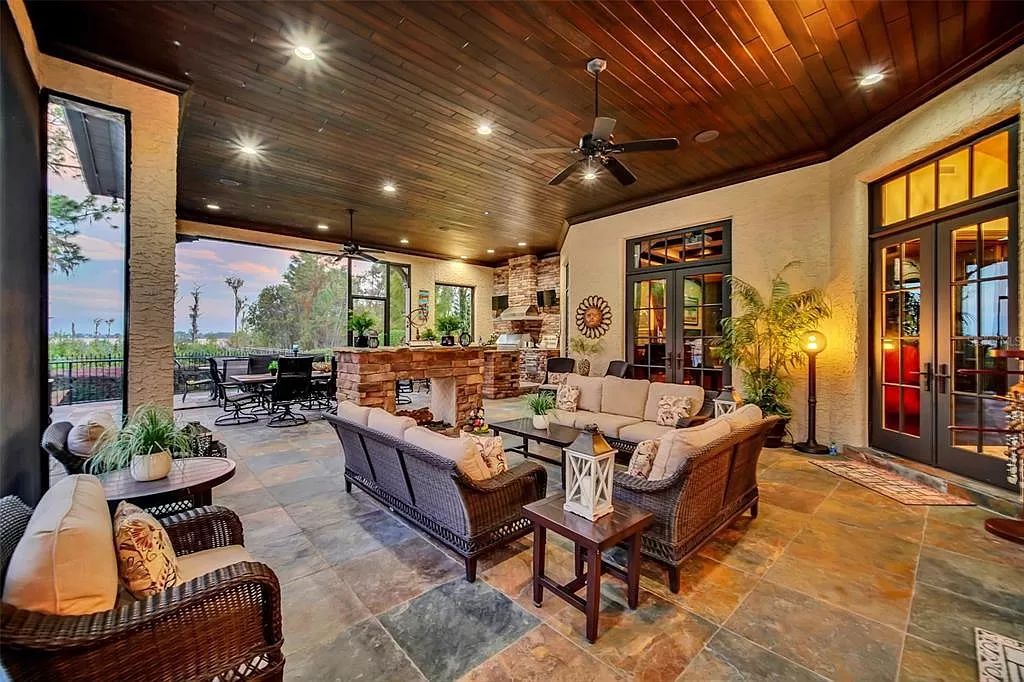 Situated within Windermere's exclusive community, this 10,485-square-foot estate at 6507 Rosella Ct embodies luxury living at its peak. Built by Stonebridge Custom Homes in 2007, the 7-bedroom, 8-bathroom property features an impressive array of amenities including a grand atrium with stunning lake views, a theater, two swimming pools, a spa, and an outdoor kitchen.