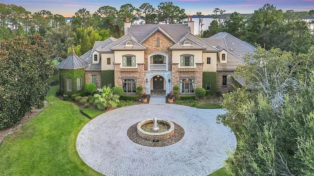 Situated within Windermere's exclusive community, this 10,485-square-foot estate at 6507 Rosella Ct embodies luxury living at its peak. Built by Stonebridge Custom Homes in 2007, the 7-bedroom, 8-bathroom property features an impressive array of amenities including a grand atrium with stunning lake views, a theater, two swimming pools, a spa, and an outdoor kitchen.