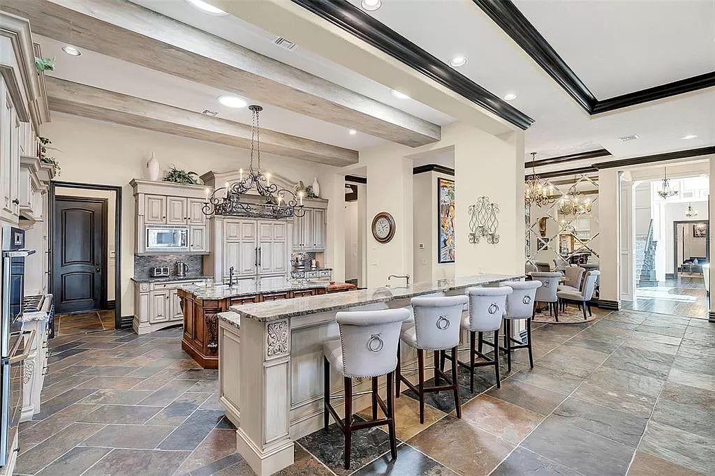 Situated within Windermere's exclusive community, this 10,485-square-foot estate at 6507 Rosella Ct embodies luxury living at its peak. Built by Stonebridge Custom Homes in 2007, the 7-bedroom, 8-bathroom property features an impressive array of amenities including a grand atrium with stunning lake views, a theater, two swimming pools, a spa, and an outdoor kitchen.
