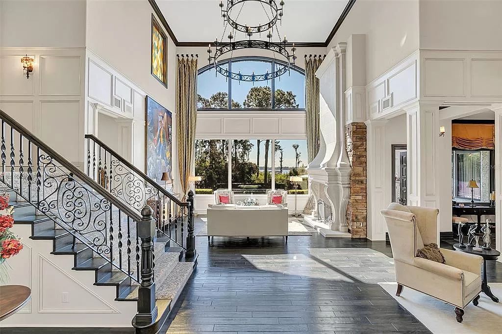Situated within Windermere's exclusive community, this 10,485-square-foot estate at 6507 Rosella Ct embodies luxury living at its peak. Built by Stonebridge Custom Homes in 2007, the 7-bedroom, 8-bathroom property features an impressive array of amenities including a grand atrium with stunning lake views, a theater, two swimming pools, a spa, and an outdoor kitchen.
