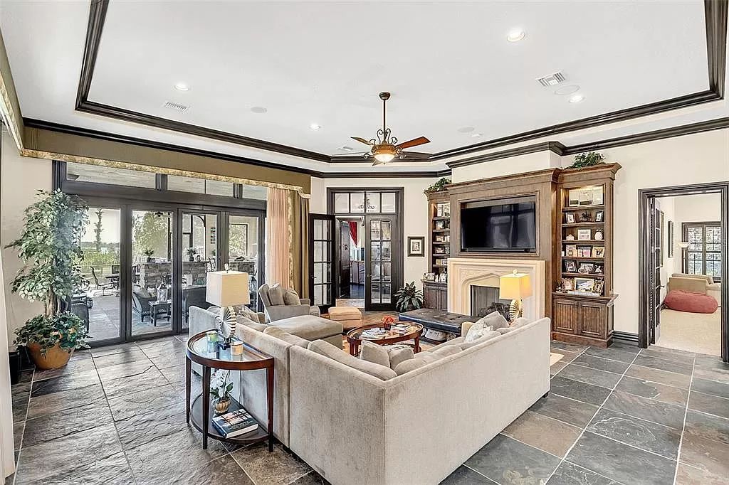 Situated within Windermere's exclusive community, this 10,485-square-foot estate at 6507 Rosella Ct embodies luxury living at its peak. Built by Stonebridge Custom Homes in 2007, the 7-bedroom, 8-bathroom property features an impressive array of amenities including a grand atrium with stunning lake views, a theater, two swimming pools, a spa, and an outdoor kitchen.