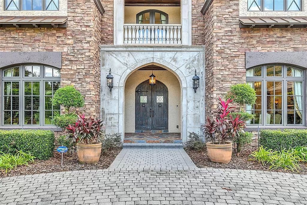 Situated within Windermere's exclusive community, this 10,485-square-foot estate at 6507 Rosella Ct embodies luxury living at its peak. Built by Stonebridge Custom Homes in 2007, the 7-bedroom, 8-bathroom property features an impressive array of amenities including a grand atrium with stunning lake views, a theater, two swimming pools, a spa, and an outdoor kitchen.