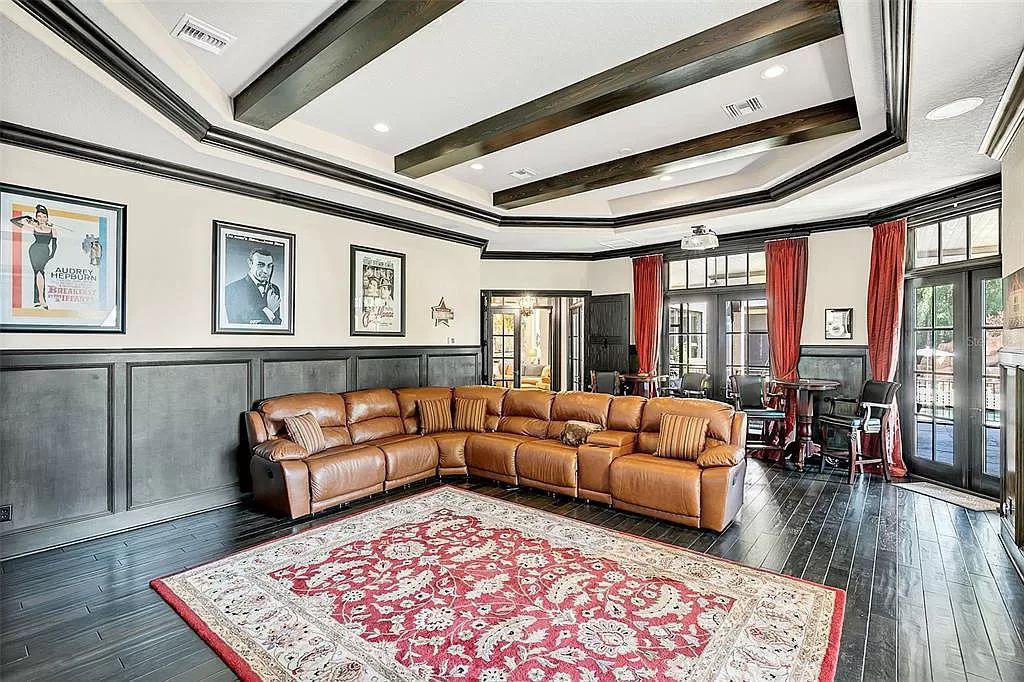 Situated within Windermere's exclusive community, this 10,485-square-foot estate at 6507 Rosella Ct embodies luxury living at its peak. Built by Stonebridge Custom Homes in 2007, the 7-bedroom, 8-bathroom property features an impressive array of amenities including a grand atrium with stunning lake views, a theater, two swimming pools, a spa, and an outdoor kitchen.