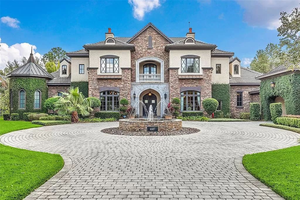 Situated within Windermere's exclusive community, this 10,485-square-foot estate at 6507 Rosella Ct embodies luxury living at its peak. Built by Stonebridge Custom Homes in 2007, the 7-bedroom, 8-bathroom property features an impressive array of amenities including a grand atrium with stunning lake views, a theater, two swimming pools, a spa, and an outdoor kitchen.